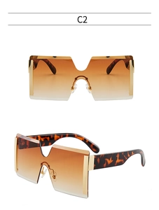 Détail de lunettes de soleil carrées sans monture avec verres dégradés marron et léopard