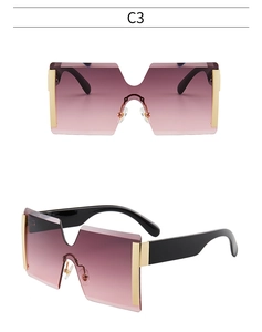 Détail de lunettes de soleil carrées sans monture avec verres dégradés violets et or