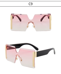 Gros plan de lunettes de soleil sans monture avec verres dégradés roses et détails dorés