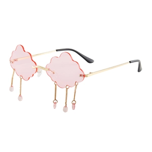 Frameless cloud-shaped sunglasses with pink lenses and gold chain teardrop charms