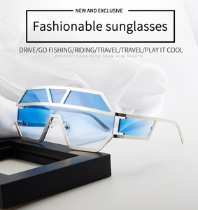 Detail of oversized futuristic sunglasses with silver hollow frame and blue lenses