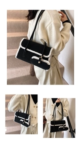 Detailed view of black underarm bag with white faux shearling trim and mini pouch
