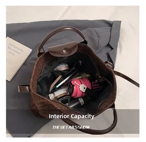 Detail view of the spacious inner storage with zipper pocket in a brown tweed tote bag