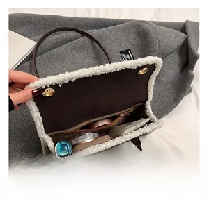 Detail view of the plush-trimmed crossbody bag interior with multiple compartments