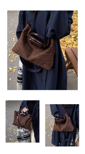 Detail of checkered tote bag showing brown quilted fabric and leather handle texture