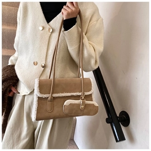Brown suede underarm bag with white faux fur trim and gold hook detail on shoulder strap