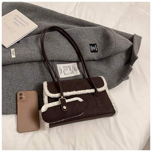 Detail of dark brown faux leather underarm bag with white faux fur trim and mini coin purse