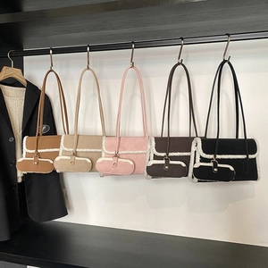 Group display of five colorful suede shoulder bags with plush fleece trim and mini purses