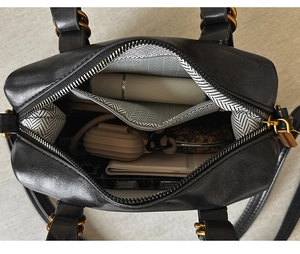 Detail view of the black bowling bag interior with herringbone lining and zip pocket