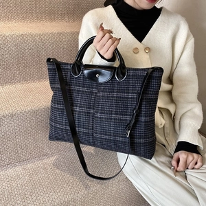 Quilted tote bag with leather handles and long shoulder strap for casual commuting
