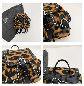 Detail view of leopard print backpack with silver metal studs and leather strap buckle