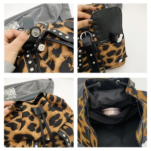 Detail view of leopard print backpack with metal rivets and magnetic closure features
