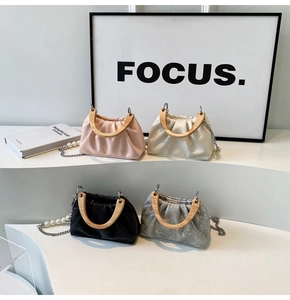 Detail of ruched cloud bags in four colors with U-shaped wooden handles and pearl chains