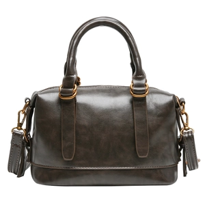 Dark brown oil wax leather bowling handbag with gold hardware and shoulder strap