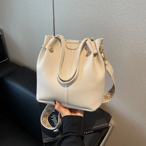 Chic beige bucket bag with litchi texture and ethnic embroidered wide strap