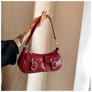 Detailed macro view of dark red vintage faux leather texture and silver buckle accents