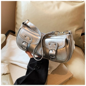 Detailed view of silver motorcycle bag with twin buckle pockets and metallic finish