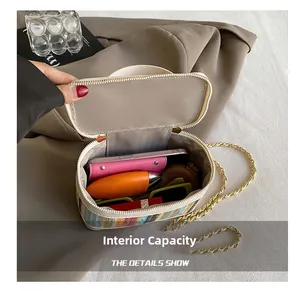 Top view of striped straw box bag showing interior capacity for phone and cosmetics