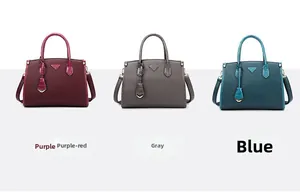 Three leather tote bags in purple, grey, and blue with crocodile texture and metal charms
