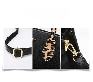Detailed shot of black litchi leather tote with leopard handle and gold hardware