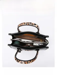 Top view of large black tote bag showing organized interior with laptop and daily essentials