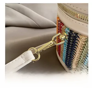 Macro shot of premium golden metal hooks and colorful woven bag strap details