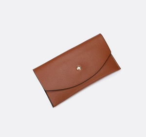 Close-up of brown pebbled texture envelope clutch bag with gold round snap button