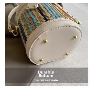 Detail view of the colorful woven bucket bag base with four golden anti-wear metal studs