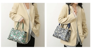 Detail of snake skin texture tote bags in green and blue-grey with metal handles