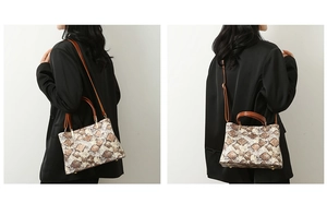 Detail of snake print tote bag with brown handles and adjustable crossbody strap