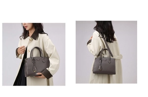 Detail of dark grey embossed leather tote with metal logo and crocodile texture side