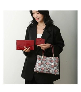 Three-piece red faux leather handbag set with snakeskin pattern and matching wallets