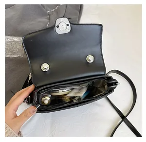 Internal view of black quilted crossbody bag showing spacious capacity for cosmetics