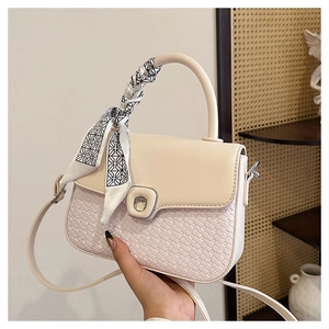 Detail of cream beige woven leather crossbody bag with decorative geometric silk scarf