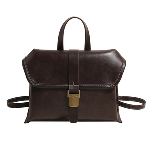 Retro dark brown faux leather backpack with white stitching and bronze metal clasp