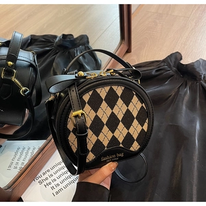 Fashionable round argyle crossbody bag with top handle and gold lettering detail