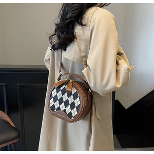 Close-up of a brown quilted round bag worn with a beige trench coat for a stylish look