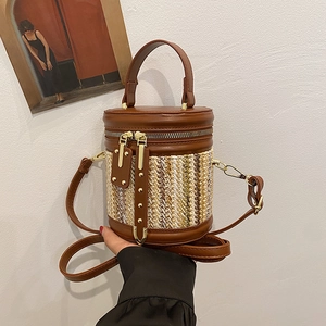 Handcrafted woven bucket bag with brown leather trim and metallic rivet detailing