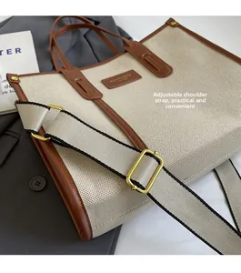 Detail of canvas tote with adjustable strap and premium brown leather trim finish