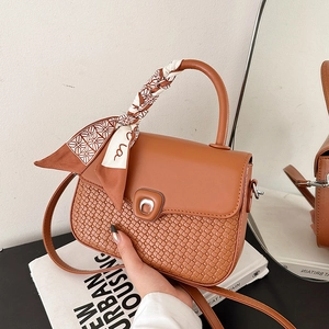 Brown vintage woven leather shoulder bag with decorative silk scarf and metal ring clasp