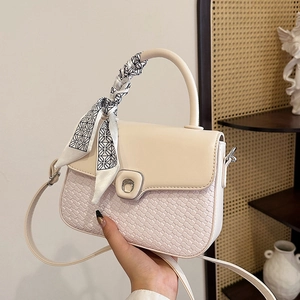 Elegant beige quilted leather crossbody bag with silk scarf handle and silver ring buckle