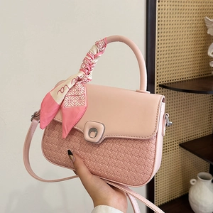 Pale pink woven crossbody bag with silk scarf handle and silver crescent lock
