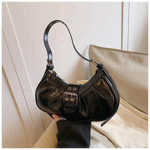 Detail of black crescent hobo bag with vintage double-row silver buckle and glossy texture