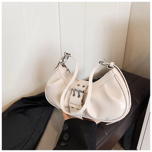 Detail of cream pleated hobo bag with silver double-hole buckle and glossy PU leather