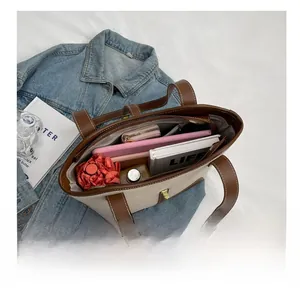 Interior view showing the large capacity of the canvas tote bag with various personal items