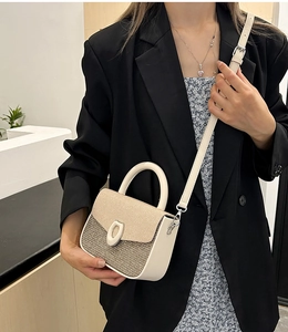 Detail of color-block contrast stitching small square bag with woven texture and metal clasp