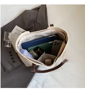 Top view of spacious tote interior showing laptop and essentials for daily commute
