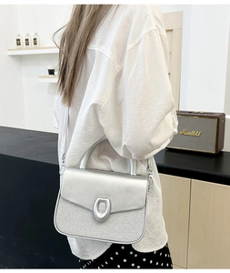 Silver metallic patchwork crossbody bag shown on model with shoulder strap detail