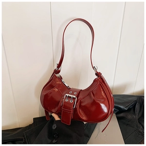 Deep red pleated crescent shoulder bag with silver buckle and glossy faux leather finish