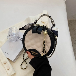 Sac rond matelassé chic en crème et noir avec bandoulière chaîne et poignée foulard soie